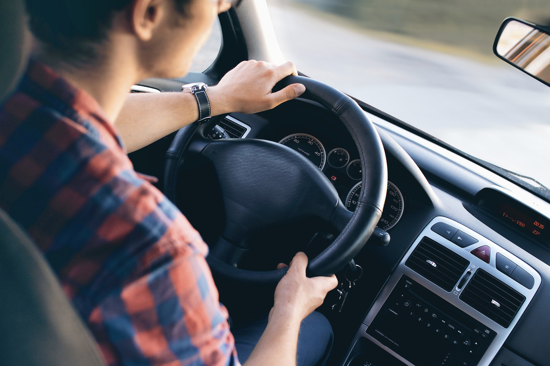 Person driving a car during a lesson with Above All L's Driving School in Auckland